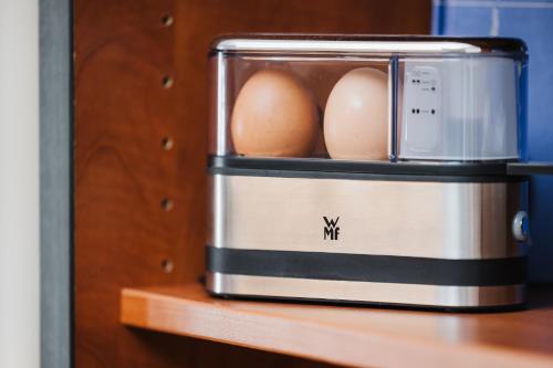 two eggs in a toaster sitting on a table at Filek House in Sibiu