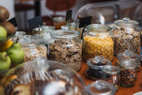 a table topped with jars of different types of nuts at Filek House in Sibiu