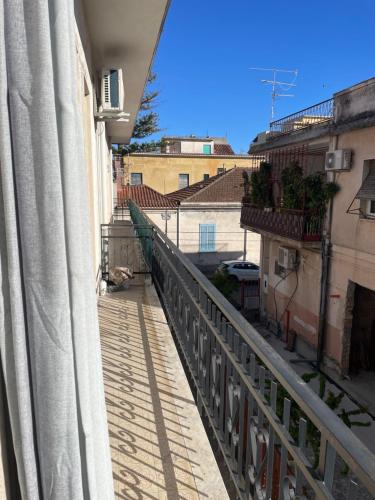 a balcony with a view of a street with buildings at Il fico in Bovalino Marina