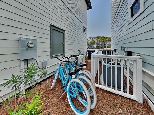 a blue bike parked next to a house at The Holland House II in Rosemary Beach