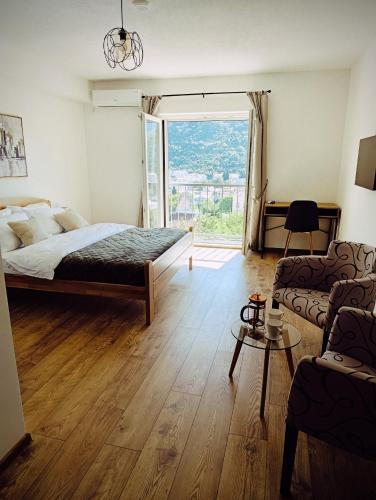 a bedroom with a bed and a large window at Villa Olea in Mostar