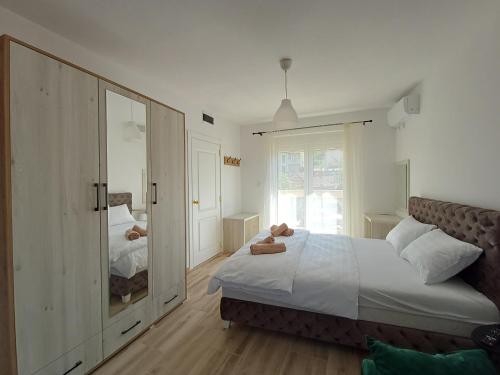 a bedroom with a large bed and a mirror at RIO Residence in Soko Banja