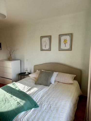 a bed in a bedroom with two pictures on the wall at POKLEKANE in Wysowa-Zdrój