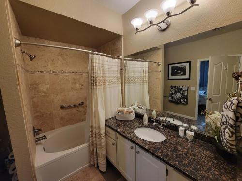 a bathroom with a sink and a tub and a shower at 2 Bedroom 2 Bathroom Ground Floor Condo Ahwatukee in Phoenix