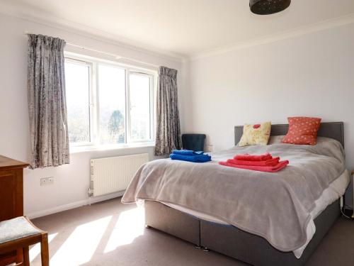 a bedroom with a bed with two towels on it at Tregoning in Lostwithiel