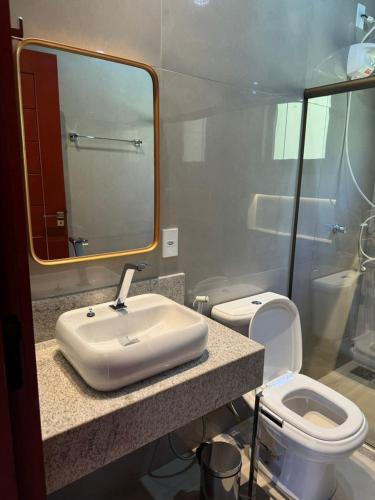 a bathroom with a sink and a toilet at Chalé Estalagem Sítio Sossego in Domingos Martins