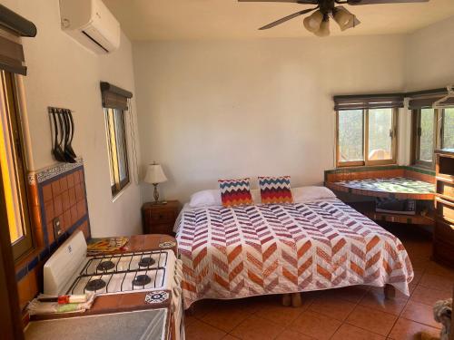a bedroom with a bed and a stove at Casitas Las Palmas - Brisa Marina in Punta Mita