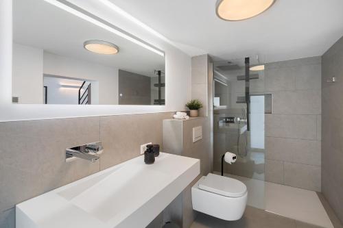 a bathroom with a white sink and a toilet at Kaisers Nescht in Vogtsburg