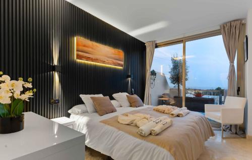 a bedroom with a large bed with towels on it at VIP AL FATTAh LUXURY in Estepona