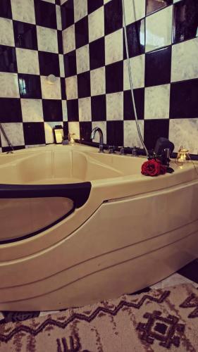 a bath tub with a red rose sitting on top of it at Bistrički mir - Imanje in Bistrica