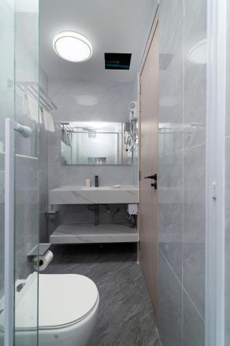a bathroom with a toilet and a sink and a mirror at Ocean Bounty in Ukulhas