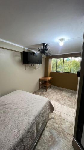 a bedroom with a bed and a ceiling fan at Hospedaje SAUNA & SPA NOAH in Bagua Grande