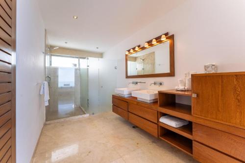 a bathroom with a sink and a mirror and a shower at 1083 - Cosmo 3A3 in Tangolunda