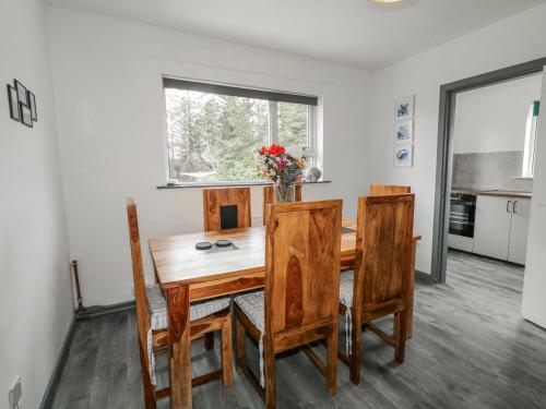 a dining room with a wooden table and chairs at The Island's View in Letterkenny