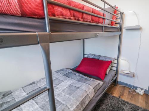a bunk bed with a red pillow on the bottom bunk at The Island's View in Letterkenny