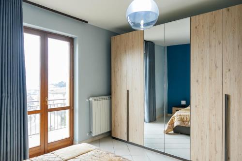 a bedroom with blue walls and a large mirror at ll Paiolo Magico in Montella