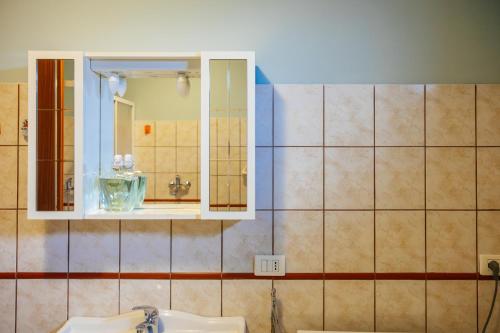a bathroom with a sink and a mirror at ll Paiolo Magico in Montella