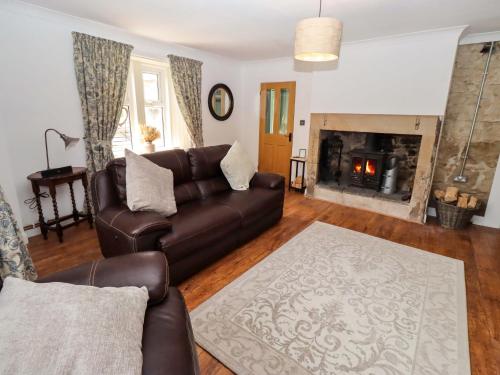 a living room with a couch and a fireplace at The Lodge in Alnwick