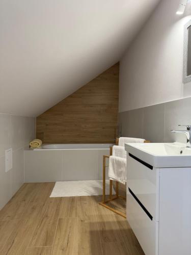 a white bathroom with a sink and a counter at MazuryLive in Węgorzewo