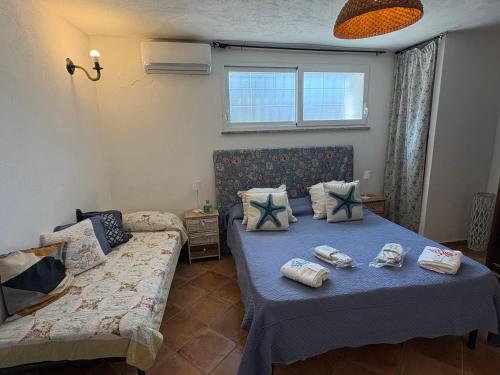 a bedroom with two beds and a couch at Villa Maria Citara Beach in Forio d'Ischia
