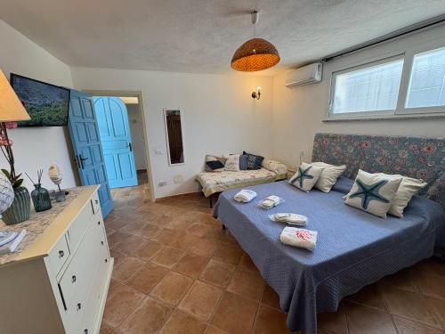 a bedroom with a bed and a living room with a couch at Villa Maria Citara Beach in Forio d'Ischia