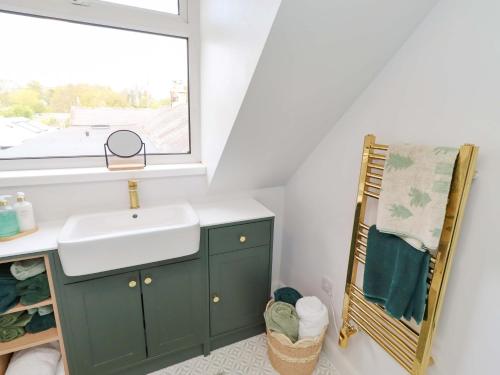 a bathroom with a sink and a window at The Lodge in Alnwick