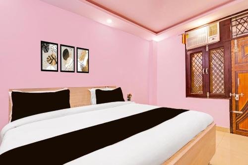 a bedroom with a large bed in a room at Hotel O Sky House Residency in New Delhi