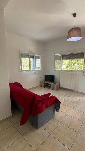 a bedroom with a bed with a red blanket on it at Apartment for Relaxed Holidays 3 in Kriezá