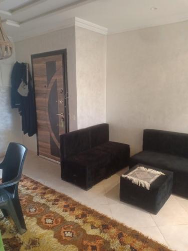 a living room with a couch and a ottoman at Rabat Luxury in Salé