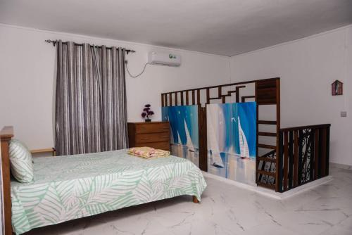 a bedroom with a bed and a dresser and a bed sidx sidx sidx sidx at Cadets Studio in Mahébourg