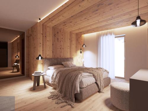 a bedroom with a large bed and a wooden wall at al Ritrovo - rooms & more in Andalo