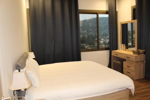 a bedroom with a white bed and a window at two seasons hotel in Bangui