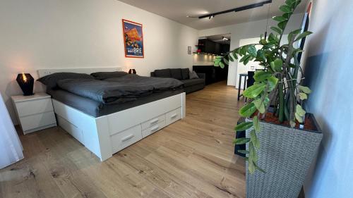 a bedroom with a bed and a living room at Bella-Lugano in Aldesago