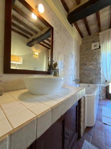 a bathroom with a white sink and a mirror at Prana Hill in Cupramontana