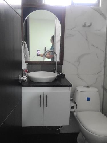 a bathroom with a sink and a toilet and a mirror at BED & Breakfast in Bogotá