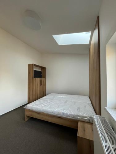 a bedroom with a bed and a skylight at U Bernarda in Slavíkovice