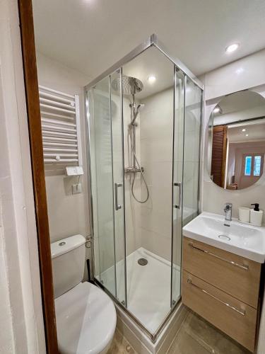 a bathroom with a shower and a toilet and a sink at L'Escale Auffan - Mourillon in Toulon