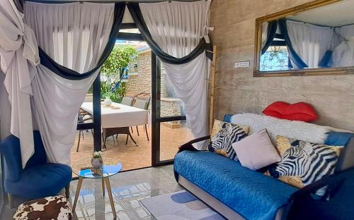 a living room with a blue couch and a mirror at Villa Stone House Poplat in Vela Luka