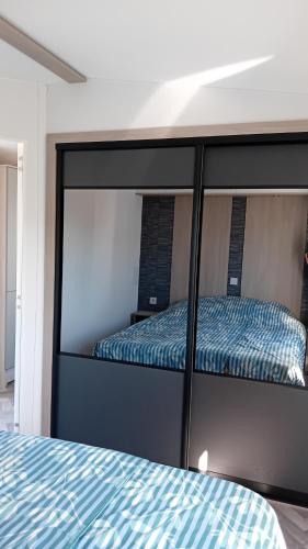 a bedroom with a bunk bed with blue sheets at Alloro-dog in Hem