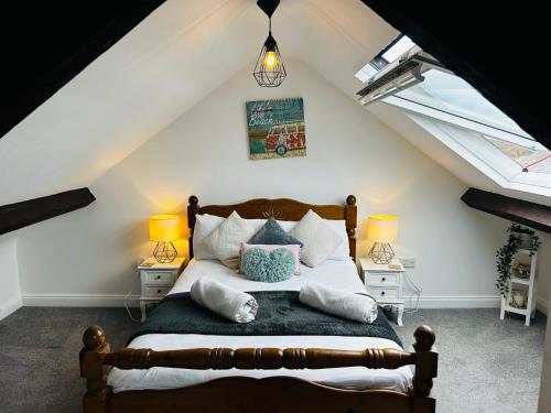 a bedroom with a bed with pillows on it at Trearddur View in Holyhead
