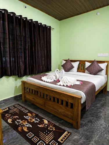 a bedroom with a large bed with towels on it at CENTAURUS Coorg HOMESTAY in Madikeri
