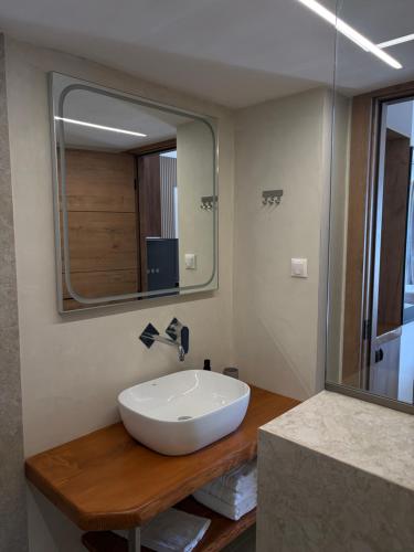 a bathroom with a large white sink and a mirror at Ammos Beach in Glida
