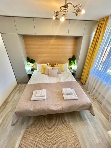 a bedroom with a large bed with two towels at Bulgarane House in Govedartsi