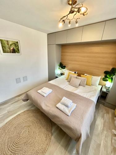 a bedroom with a large bed with two towels at Bulgarane House in Govedartsi