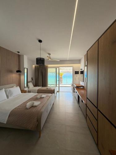 a hotel room with two beds and a bathroom at Ammos Beach in Glida