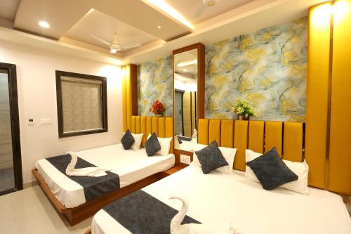 a hotel room with two beds and a painting at Hotel ELITE CHOICE in Ajmer