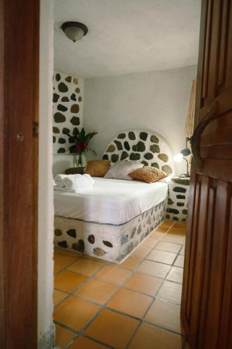 a bedroom with a bed in a room at Jungle River Lodge in La Ceiba