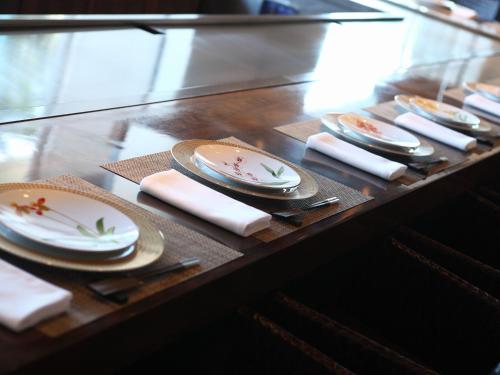 a table with plates and napkins on it at Hotel La Suite Kobe Harborland in Kobe