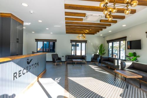 a living room with couches and a bar at Santana Resort Otel in Trabzon