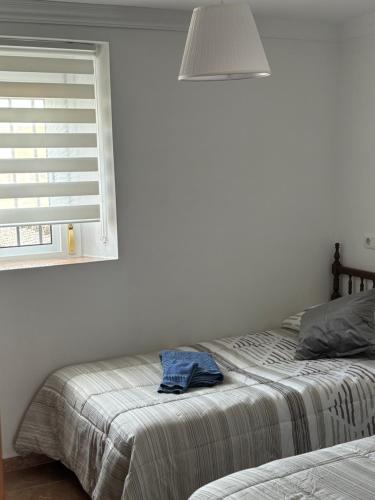 a bedroom with a bed and a window with a pillow at Casa del Abuelo in Setenil
